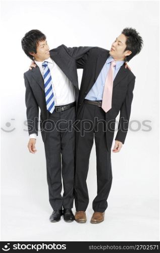 Businessmen grappling each shoulder