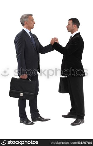 Businessmen gripping hands