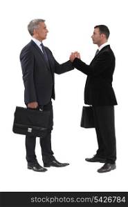 Businessmen gripping hands
