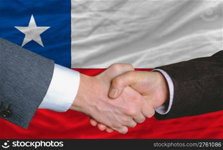 businessmen handshakeafter good deal in front of chile flag