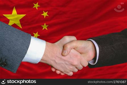 businessmen handshakeafter good deal in front of china flag