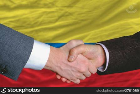 businessmen handshakeafter good deal in front of columbia flag