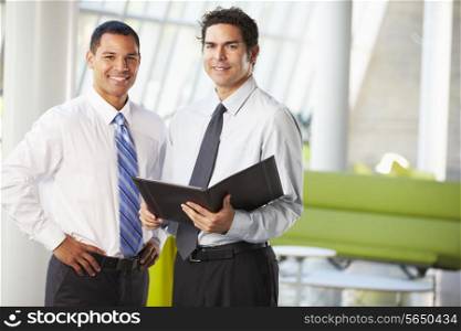 Businessmen Having Informal Meeting In Modern Office