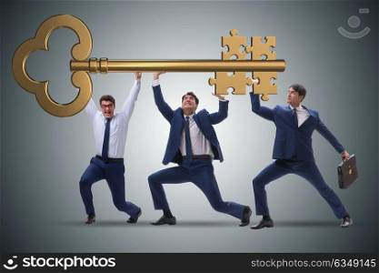Businessmen holding giant key in business concept