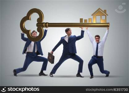 Businessmen holding giant key in real estate concept