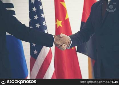 Businessmen holding hands With an international flag background