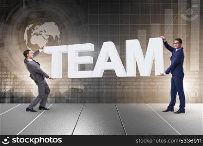 Businessmen holding word team in teamwork concept