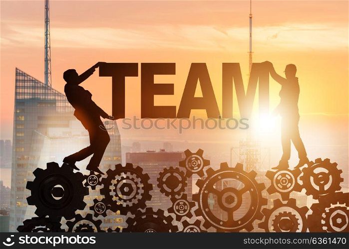 Businessmen holding word team in teamwork concept