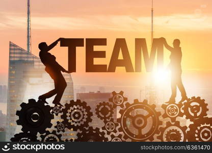 Businessmen holding word team in teamwork concept