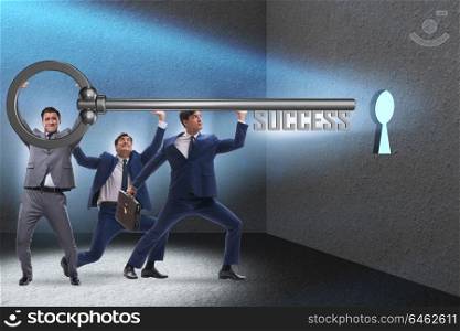 Businessmen in business success concept with key