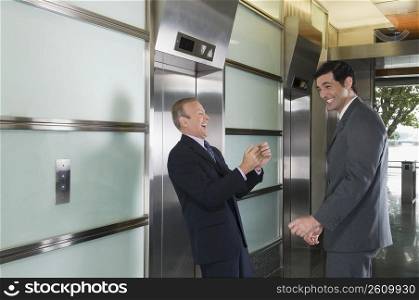 Businessmen laughing in a corridor
