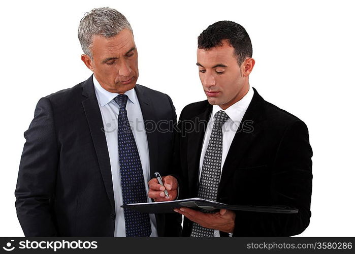 Businessmen looking at a clipboard