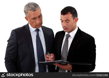 Businessmen looking at a clipboard