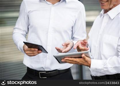 businessmen looking tablets