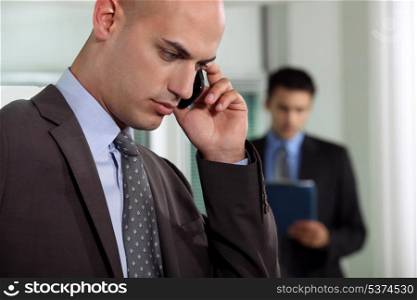 Businessmen negotiating over the phone
