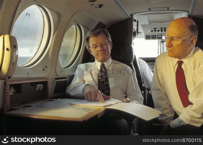 Businessmen on an Airplane