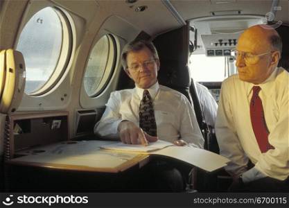 Businessmen on an Airplane