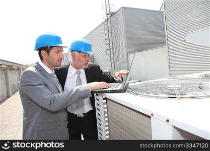 Businessmen on industrial site