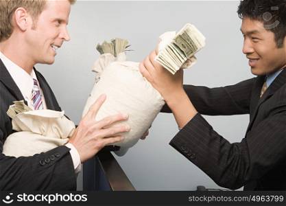 Businessmen passing money