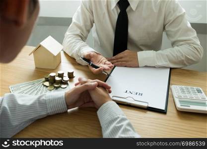 Businessmen present price contract on trading - rent a house to customers. Insurance Agent house. Business concept.