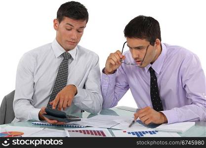 Businessmen scrutinizing financial results