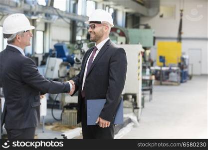 Businessmen shaking hands in metal industry