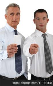 Businessmen showing blank business cards