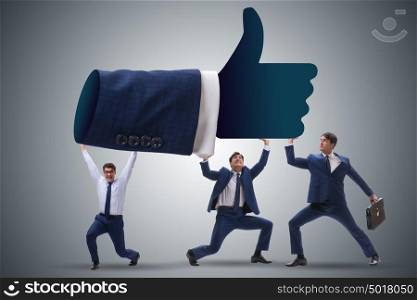 Businessmen supporting thumbs up gesture