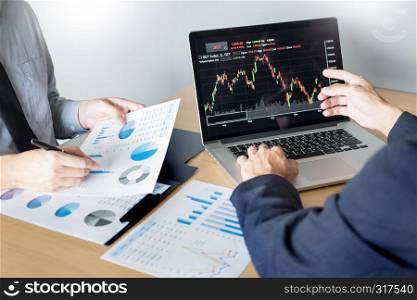 Businessmen talking about stock market invest trading online analysis discussing financial graph for investment purposes discussion in traders office