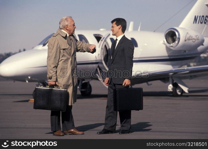 Businessmen Talking On Runway