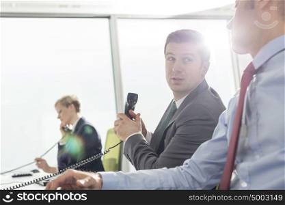 Businessmen talking while working at modern office