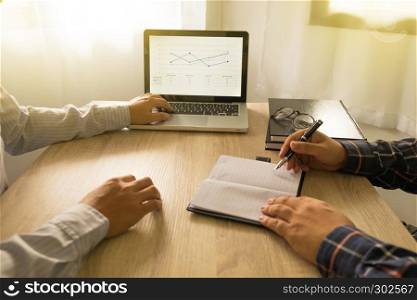 Businessmen using laptop to situation on the market value at meeting