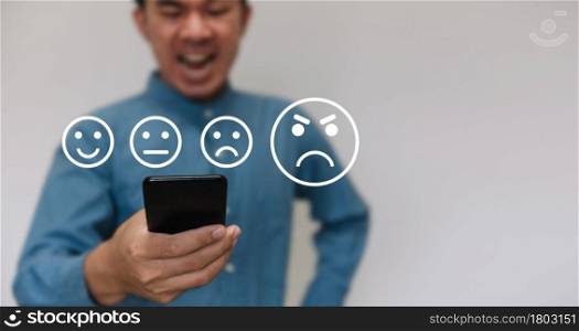 Businessmen wearing a light blue shirt to selecting the level of satisfaction score icons with copy space. Customer service experience and business satisfaction survey concept