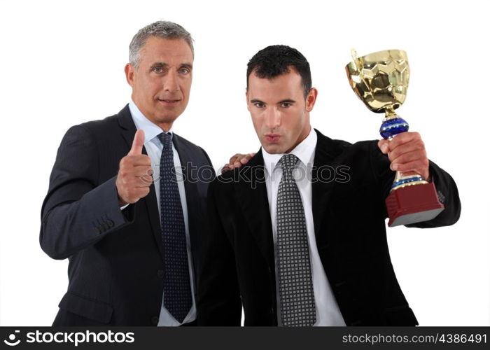 Businessmen with a trophy