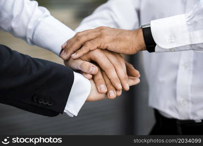 businessmen with hands together