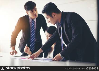 businessmen working and point on graph financial diagram and analysis documents on office table