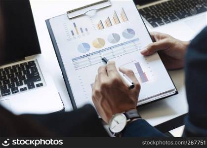 Businessmen working at office with laptop data spreadsheet documents