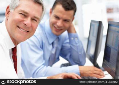 Businessmen working on computers