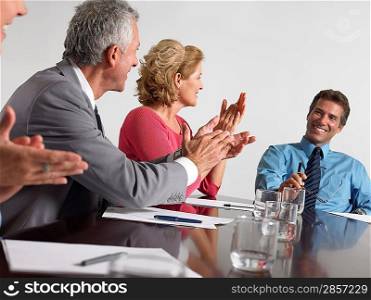 Businesspeople applauding in conference meeting