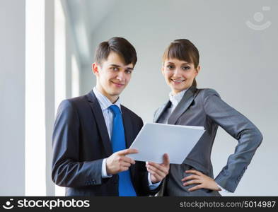 Businesspeople at work. Young happy businessman and businesswoman people discussing project