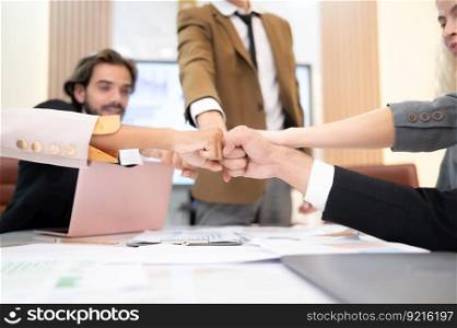 Businesspeople can motivate each other by joining hands.