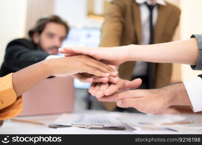 Businesspeople can motivate each other by joining hands.