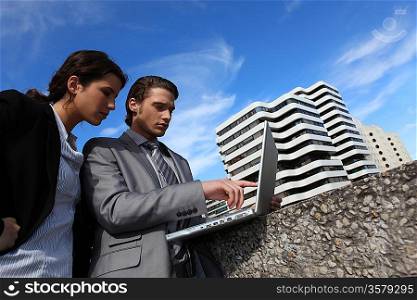 Businesspeople connecting with laptop