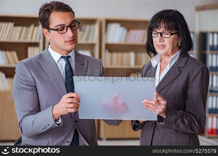 Businesspeople discussing business results on tablet computer
