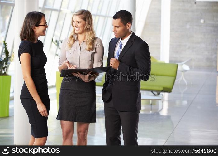 Businesspeople Having Informal Meeting In Modern Office