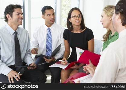 Businesspeople Having Informal Office Meeting