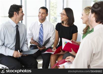 Businesspeople Having Informal Office Meeting