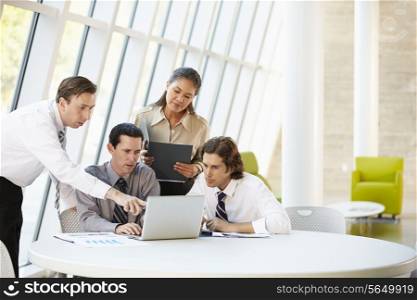 Businesspeople Having Meeting Around Table In Modern Office