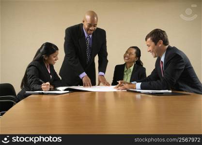 Businesspeople having meeting at conference table.