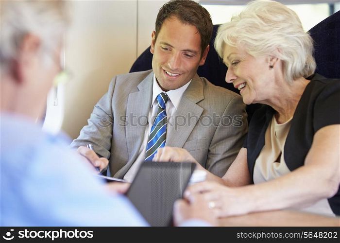 Businesspeople Having Meeting On Train